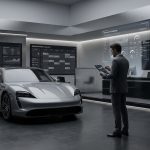 Modern car showroom with a silver-grey car, large digital screens displaying data visualizations, and a man in a suit using a tablet.